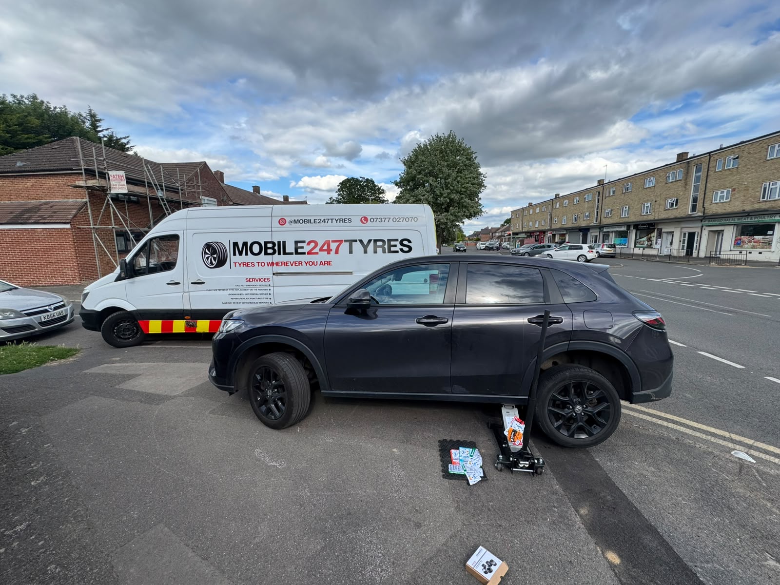 Mobile 247 Tyres fitting van and customer car on a Slough street